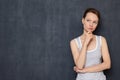 Portrait of thoughtful focused young woman being deep in thoughts