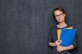 Portrait of thoughtful focused young woman holding folders and pen Royalty Free Stock Photo