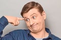 Portrait of thoughtful funny mature man touching temple with finger Royalty Free Stock Photo