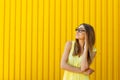 Portrait of a thoughtful girl wearing glasses looking up over ye Royalty Free Stock Photo