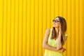 Portrait of a thoughtful girl wearing glasses looking up over ye Royalty Free Stock Photo