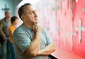 Portrait of thoughtful elderly man examining exposition in museum hall of applied arts Royalty Free Stock Photo