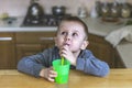 Portrait of thoughtful little boy in the kitchen at home. Royalty Free Stock Photo