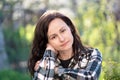 Portrait of thoughtful pretty young woman relaxing outdoors on warm spring sunny day Royalty Free Stock Photo