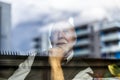 Senior man looking through window Royalty Free Stock Photo
