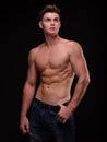 Healthy teenage guy shirtless on a black background. Sporty young men. Muscle building concept. Royalty Free Stock Photo