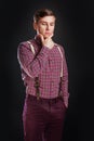 Portrait of thoughtful serious clever scientific man in vintage shirt bow tie with hairstyle keeping hand under chin while stand Royalty Free Stock Photo