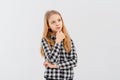 Portrait of thoughtful teen girl , looking aside and planning smth in her head, thinking, standing in casual plaid shirt over