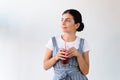 portrait of thoughtful woman with glass of detox drink looking away