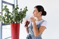 portrait of thoughtful woman with glass of detox drink