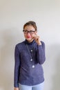 Portrait of a thoughtful young asian Chinese woman in eyeglasses looking up at copy space with hand on her head isolated over Royalty Free Stock Photo