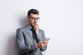 Portrait of a thoughtful young man with a pen and a diary in a studio, planning. Royalty Free Stock Photo