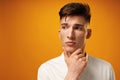 Portrait of thoughtful young man who looks away touching his chin Royalty Free Stock Photo