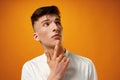 Portrait of thoughtful young man who looks away touching his chin Royalty Free Stock Photo