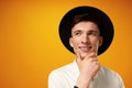 Portrait of thoughtful young man who looks away touching his chin Royalty Free Stock Photo