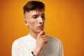 Portrait of thoughtful young man who looks away touching his chin Royalty Free Stock Photo