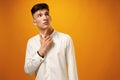 Portrait of thoughtful young man who looks away touching his chin Royalty Free Stock Photo