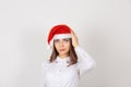 Portrait of thoughtful young woman in Christmas hat, daydreaming about something, looking up isolated white background. Human Royalty Free Stock Photo