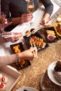 Portrait of three beautiful young women eating japanese food and drinking wine at home. Royalty Free Stock Photo