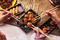 Portrait of three beautiful young women eating japanese food and drinking wine at home. Royalty Free Stock Photo