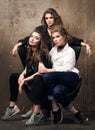 Portrait of three beautiful young women posing on a chair. Modern appearance Royalty Free Stock Photo