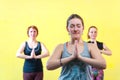 Portrait of three caucasian women practicing yoga