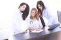 Portrait of three confident female doctors standing with arms crossed