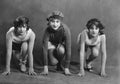 Portrait of three female runners in starting position