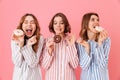 Portrait of three funny young girl dressed in pajamas