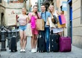 Portrait of three girls and one man standing with shopping bags Royalty Free Stock Photo