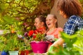 Happy girls friends having fun potting flowers Royalty Free Stock Photo