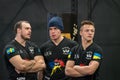 Portrait of three male arm wrestlers from Sweden and Ukraine.