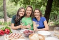 Portrait Of Three Mature Women Enjoying Barbeque Party , Drinking Wine And Smiling Royalty Free Stock Photo