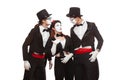 Portrait of three mime artists performing, isolated on white background. Man is telling interesting story, his