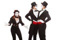 Portrait of three mime artists performing, isolated on white background. Mimes stand thinking. Symbol of finding