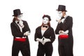 Portrait of three mime artists performing, isolated on white background. Mimes stand thinking. Symbol of finding