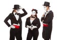 Portrait of three mime artists performing, isolated on white background. Mimes stand thinking. Symbol of finding