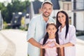 Portrait of three nice lovely cheerful affectionate people dad mom teen daughter embracing showing heart shape outside Royalty Free Stock Photo