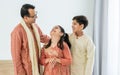 Portrait three people of happy Indian single father, son, daughter hugging, talking with warmth, love, wearing traditional clothes