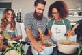 Three friends cooking spaghetti Royalty Free Stock Photo