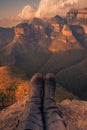 Portrait of the Three Rondavels with a persons shoes in foreground at sunset golden hour. Mpumalanga, South Africa Royalty Free Stock Photo