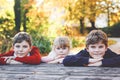 Portrait of three siblings children. Two kids brothers boys and little cute toddler sister girl having fun together in Royalty Free Stock Photo