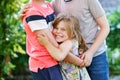 Portrait of three siblings children. Two kids brothers boys and little cute toddler sister girl having fun together in Royalty Free Stock Photo