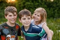 Portrait of three siblings children. Two kids brothers boys and little cute toddler sister girl having fun together on Royalty Free Stock Photo