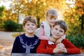 Portrait of three siblings children. Two kids brothers boys and little cute toddler sister girl having fun together in Royalty Free Stock Photo