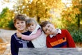 Portrait of three siblings children. Two kids brothers boys and little cute toddler sister girl having fun together in Royalty Free Stock Photo