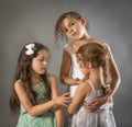 Big sister sweetly touching younger sibling on face Royalty Free Stock Photo