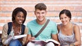 They love studying. Portrait of three smiling students on the steps of their college campus.