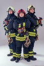 Portrait three strong fireman men in fireproof uniform white background studio