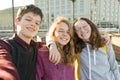 Portrait of three teen friends boy and two girls smiling and taking a selfie outdoors Royalty Free Stock Photo